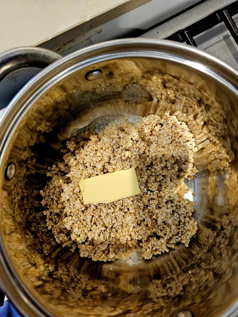 Oats and butter in a steel pot